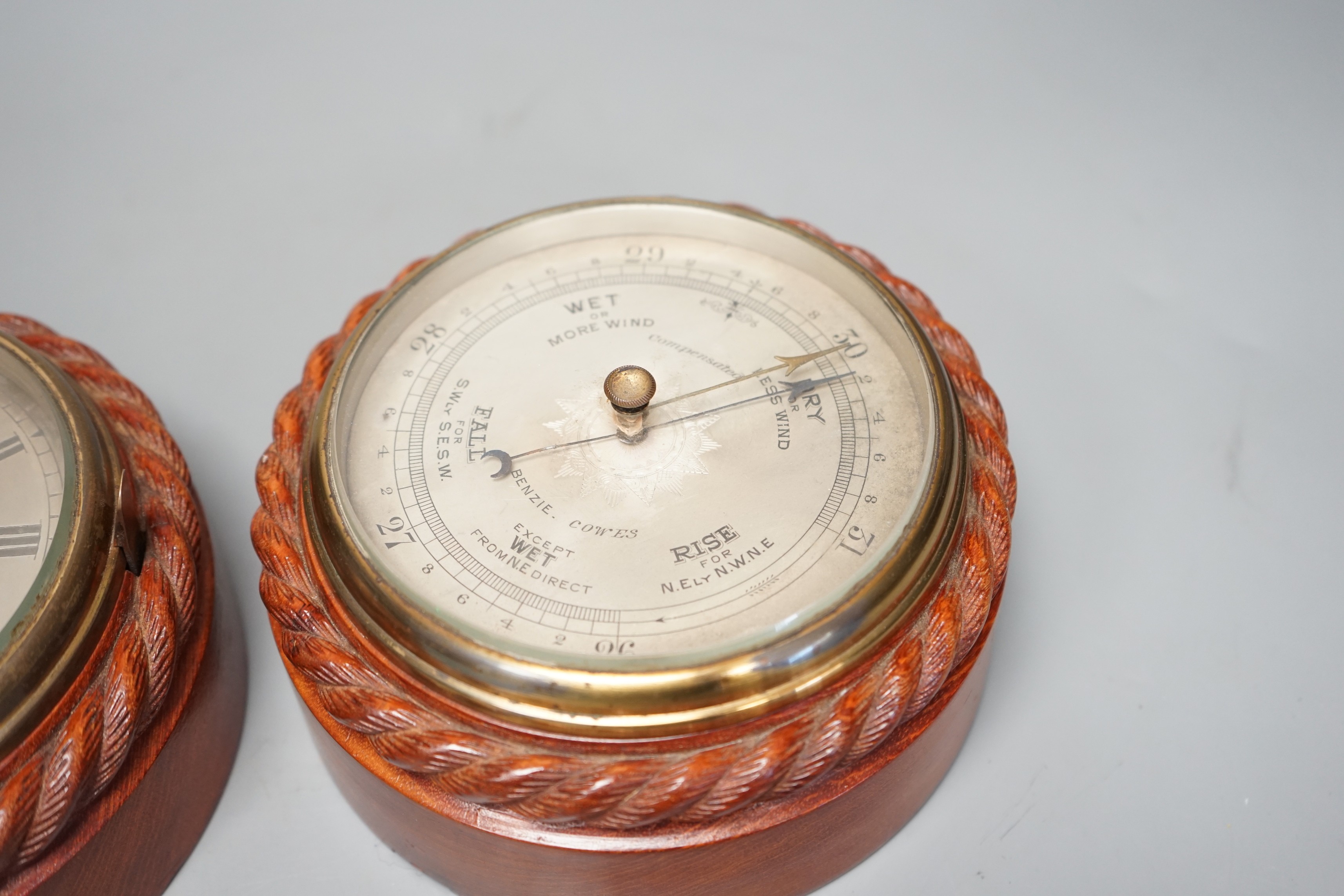A Victorian teak cased bulkhead timepiece by Benzie, Cowes, Isle of Wight with matching aneroid barometer, both with carved rope twist cases, 15cm. diam.